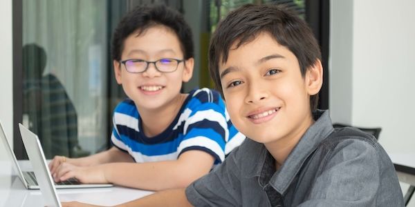Asian students boy using laptop learning in the classroom at school