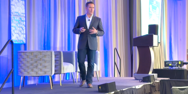 Curtiss Barnes, 1EdTech CEO, on stage at the 2026 Digital Credentials Summit